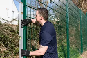 man putting up a fence 