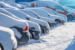 snow covered cars in car park